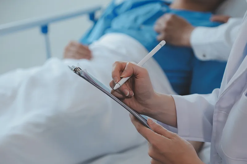 A patient being assessed after colorectal surgery