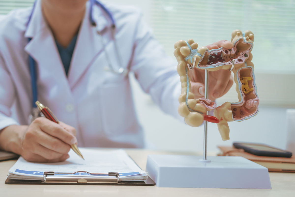 Alt text: Consultant colorectal surgeon explaining common colorectal conditions to a patient