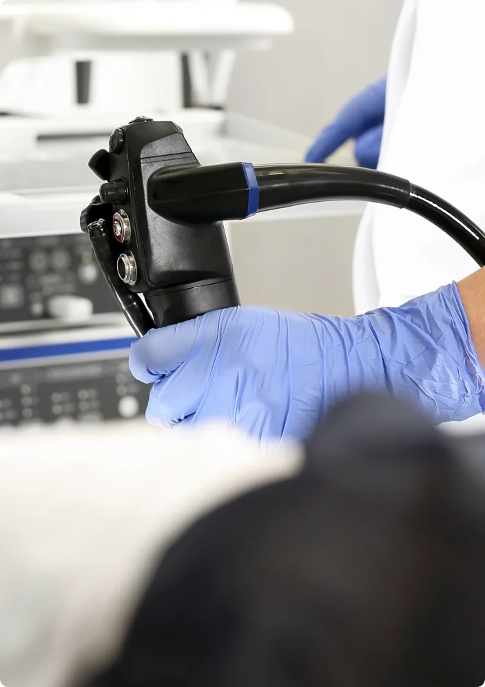 A doctor holding an endoscope for a colonoscopy screening